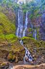 Indonesia. Tumpak Sewu waterfall flowing into a turquoise pool below. It is located near Lumajang. Art Print